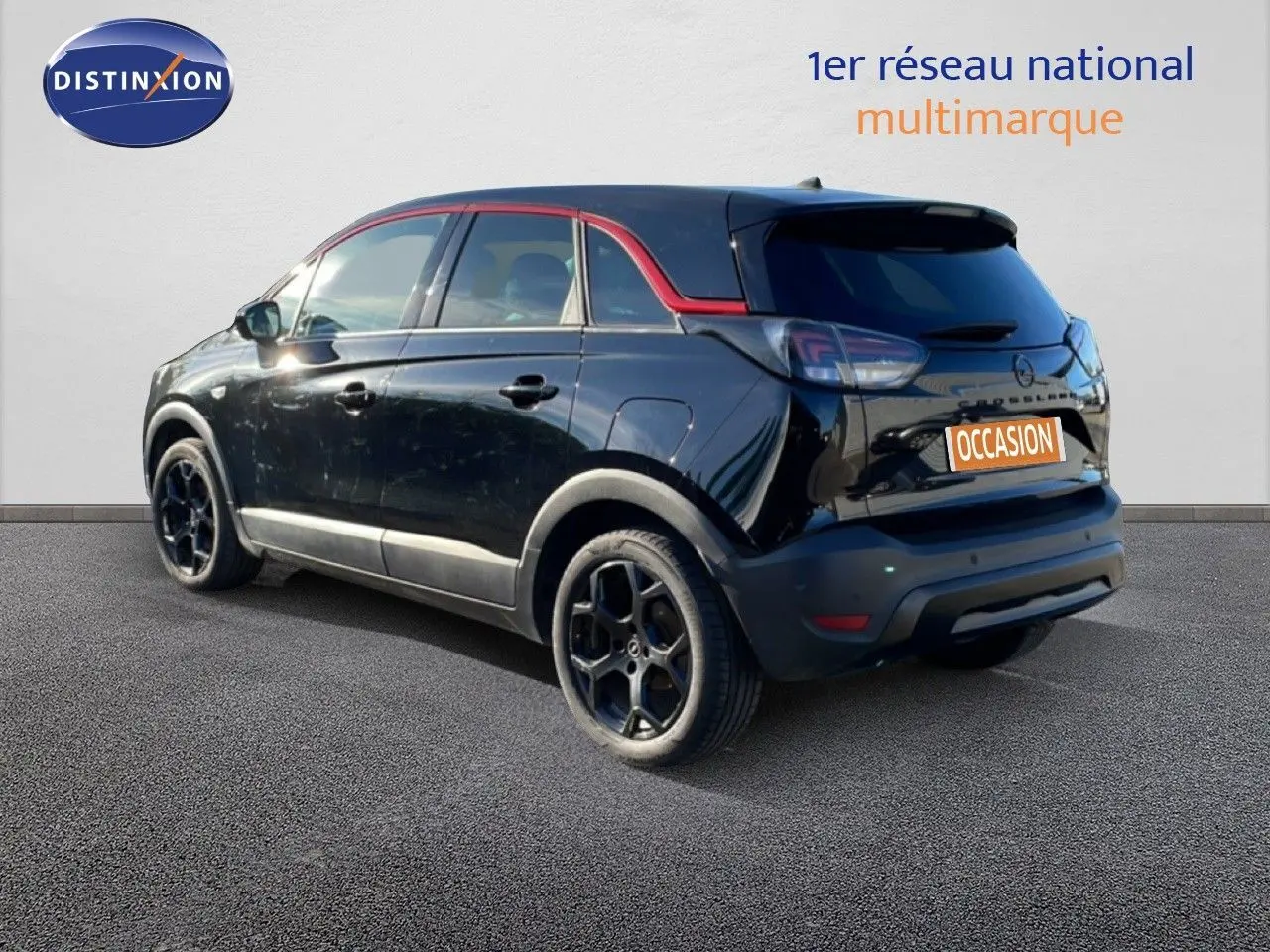 Opel Crossland noir Karbon Metal en 3/4 arrière droit, avec jantes noires et toit noir souligné de rouge.
