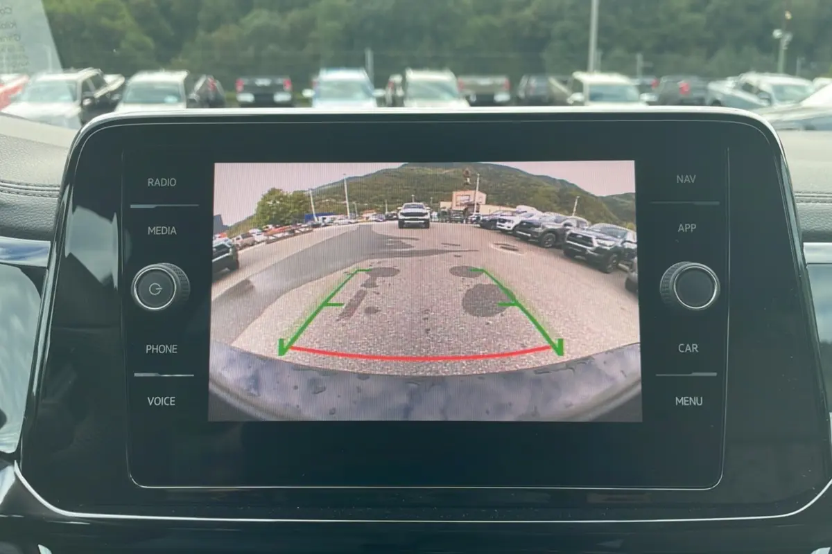 Vue de l'écran de la caméra de recul du Volkswagen T-Roc noir grenadilla, affichant l'arrière du véhicule en stationnement.