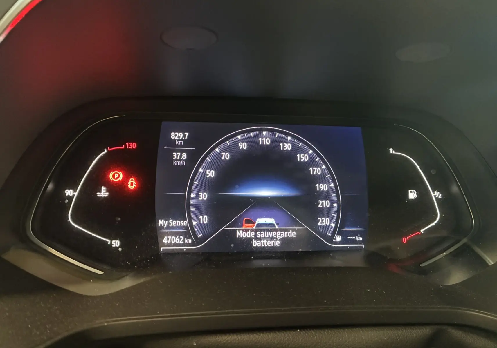 Tableau de bord numérique du Renault Captur bleu 1.3 TCE 140 Intens, affichant la vitesse et alertes batterie.