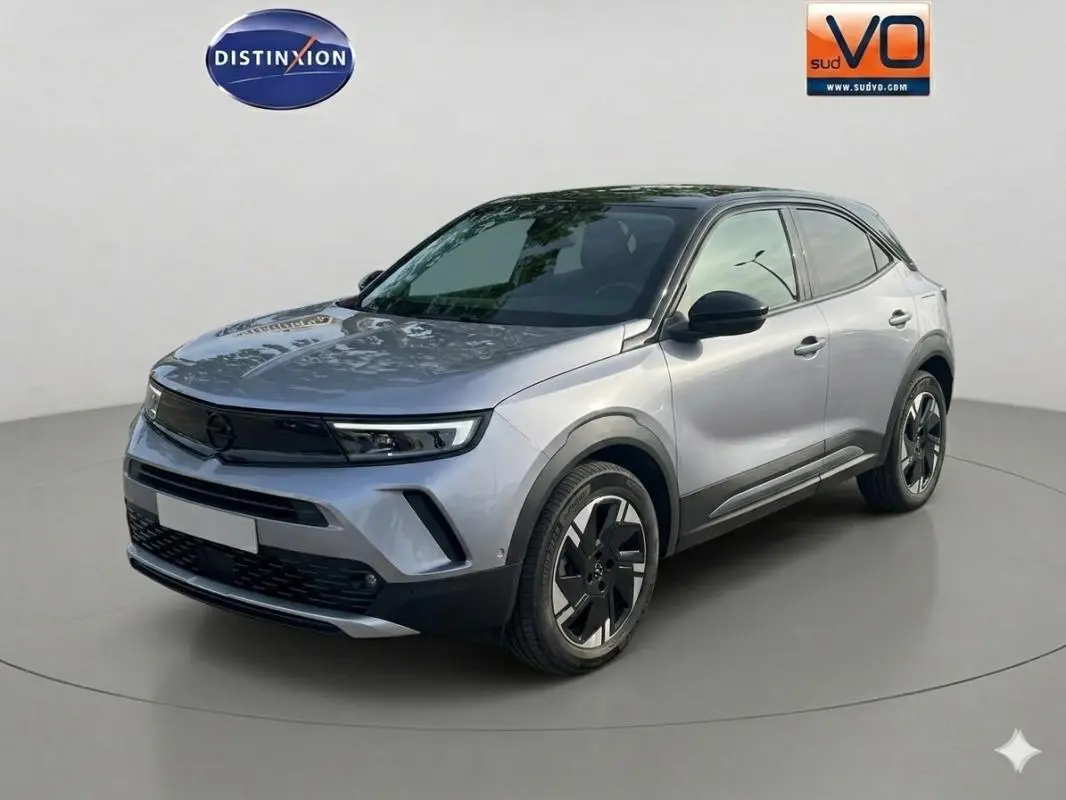 Vue 3/4 avant droit d'un Opel Mokka électrique gris avec jantes alliage 17 pouces et vitres surteintées.
