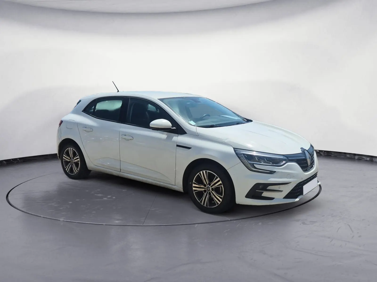 Renault Mégane 1.5 Blue dCi 115 Evolution blanche vue 3/4 avant droit sur parking ensoleillé.