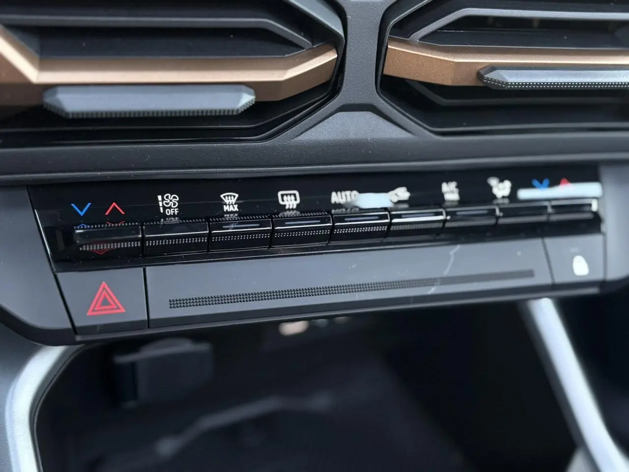 Gros plan sur la console centrale du Dacia Bigster 2026, avec commandes climatisation et boutons noirs mats.