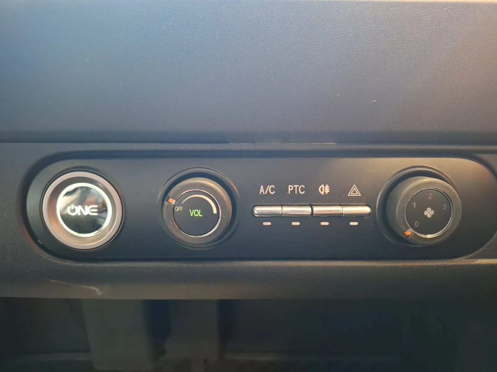 Gros plan sur la console centrale du SIMPLICI S1 gris perle 2025, avec commandes de climatisation et volume.