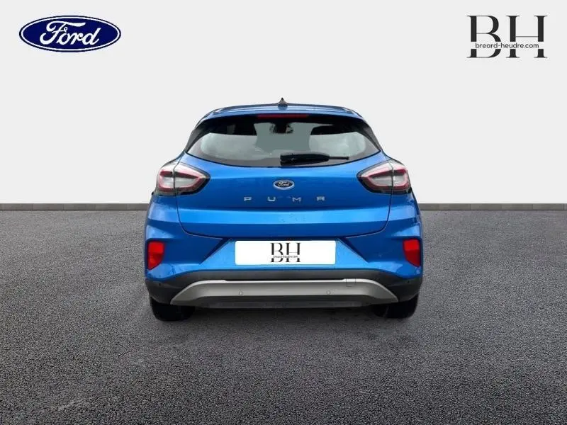 Vue arrière du Ford Puma 2023 en bleu Fashion Island métallisé, avec feux arrière distinctifs et logo central.