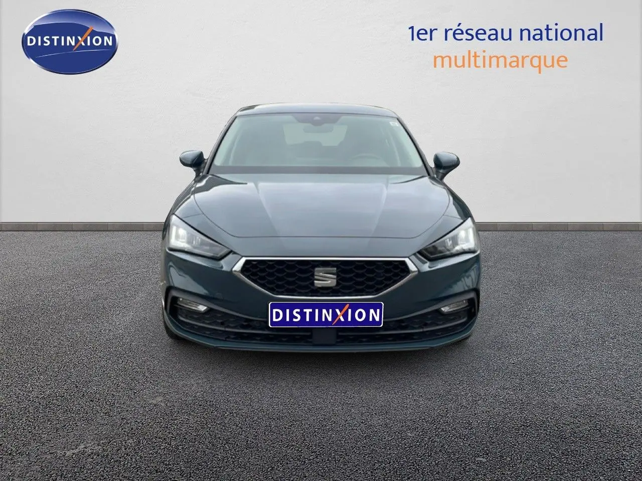 Vue avant d'une SEAT LEON 2.0 TDI 115CH STYLE XL en bleu fjord, avec calandre hexagonale et phares LED allumés.