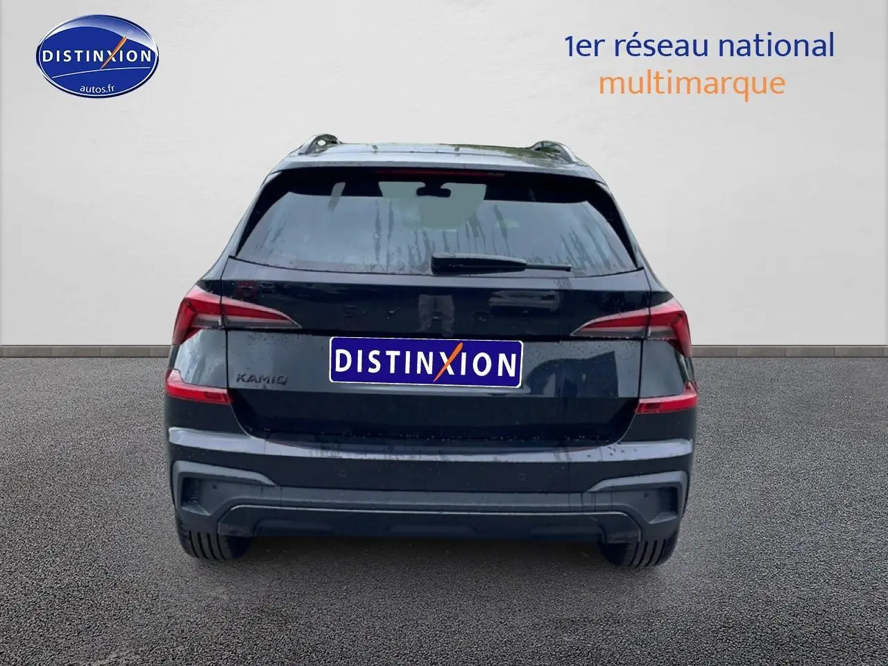 Vue arrière d'un Skoda Kamiq noir 2026 avec feux LED et barres de toit visibles sur fond clair.
