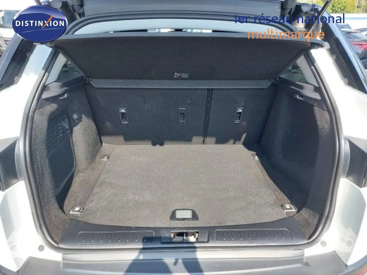 Coffre ouvert vu de l'arrière d'un Range Rover Evoque blanc 2018, espace de chargement propre et spacieux.