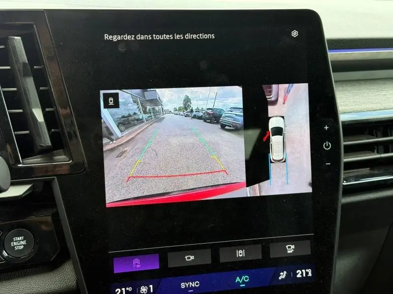 Écran central montrant la caméra de recul et vue 360 du Renault Austral Rouge Flamme, intérieur avec tableau de bord moderne.