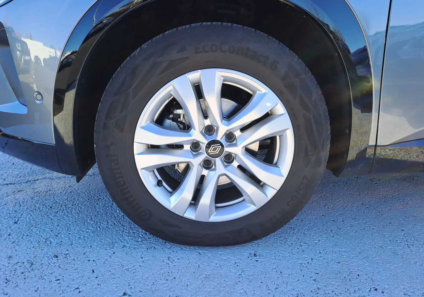 Gros plan sur la roue avant droite du Renault Austral gris schiste, mettant en valeur la jante alliage et le pneu Continental.