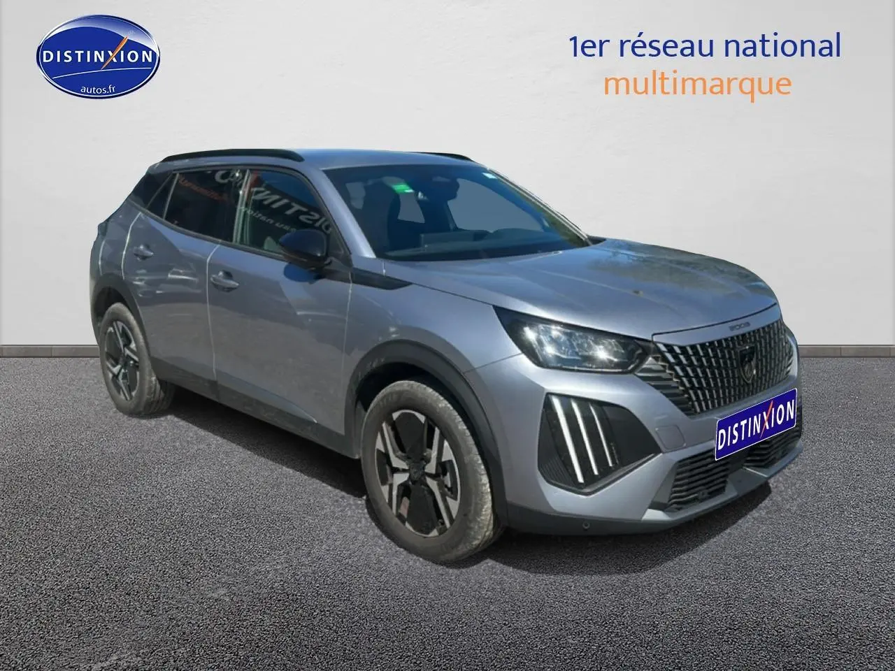Peugeot 2008 gris artense vue 3/4 avant droit avec calandre distinctive et jantes alliage noires.