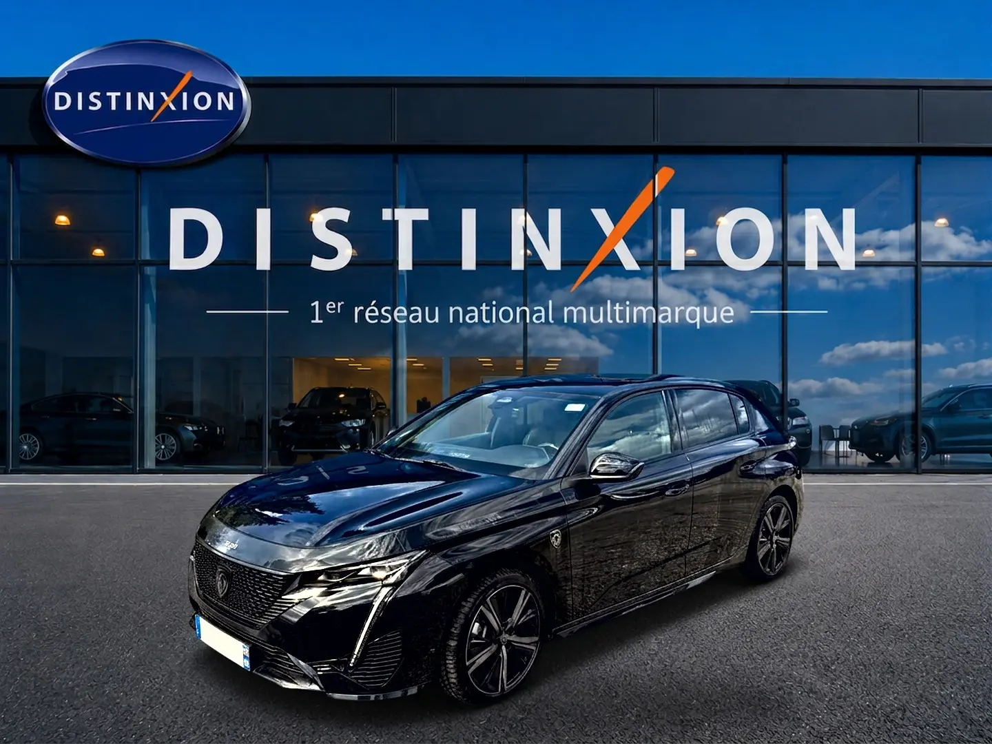 Peugeot 308 1.2 hybrid 145 GT noir vue 3/4 avant, jantes alliage et calandre distinctive sous un ciel bleu.
