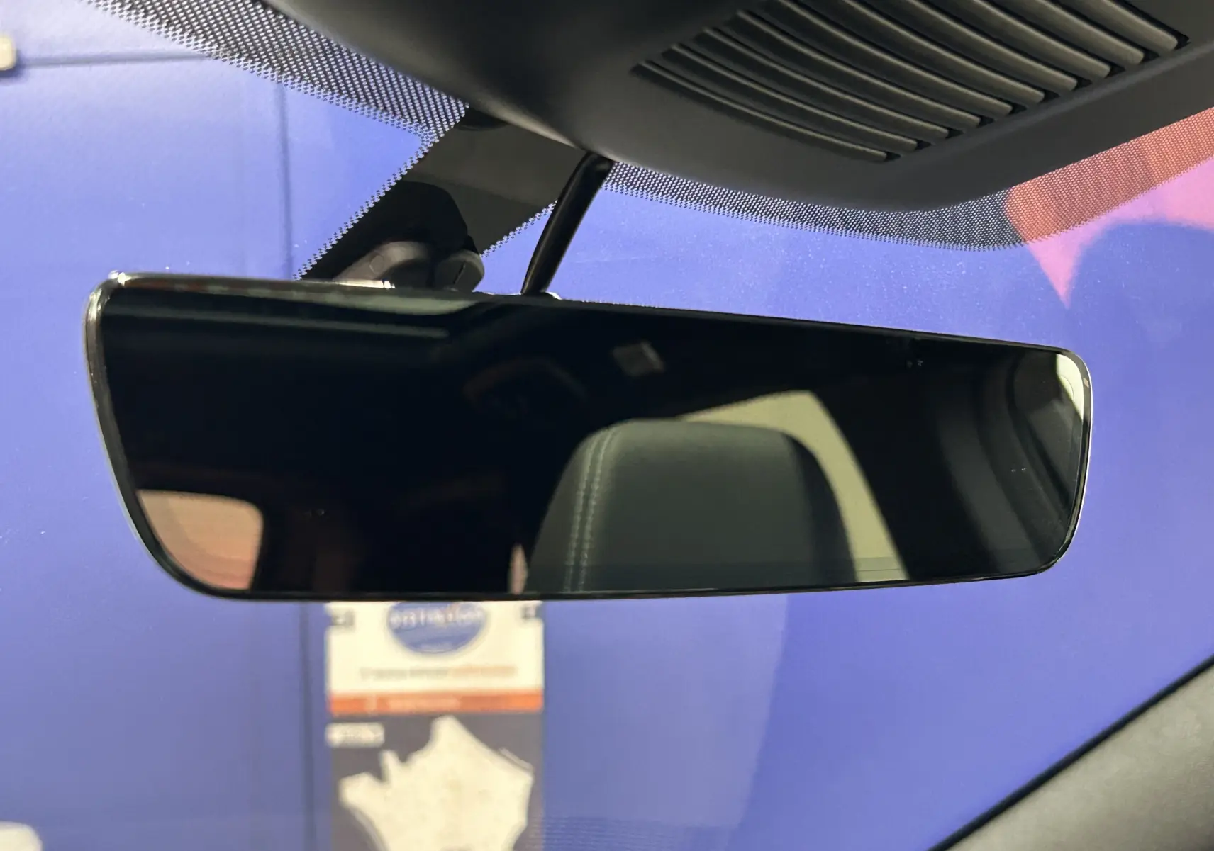 Rétroviseur intérieur noir avec reflet du siège avant dans un Nissan Qashqai gris céramique 2025.