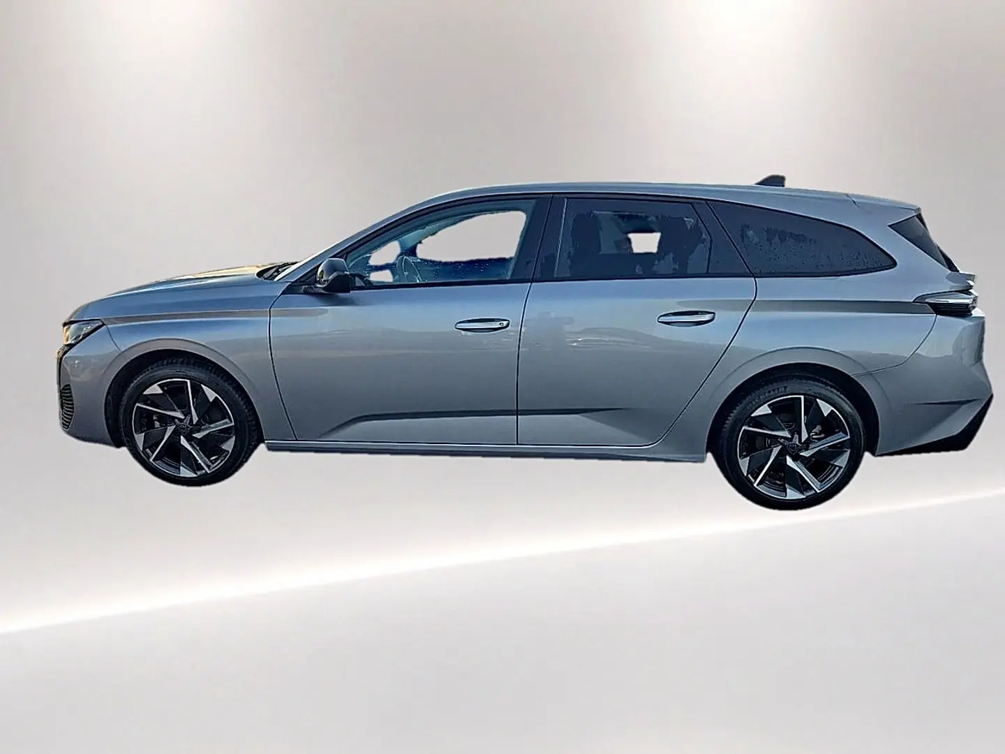 Peugeot 308 SW gris artense vue de profil côté gauche, avec jantes alliage noires et vitres surteintées.