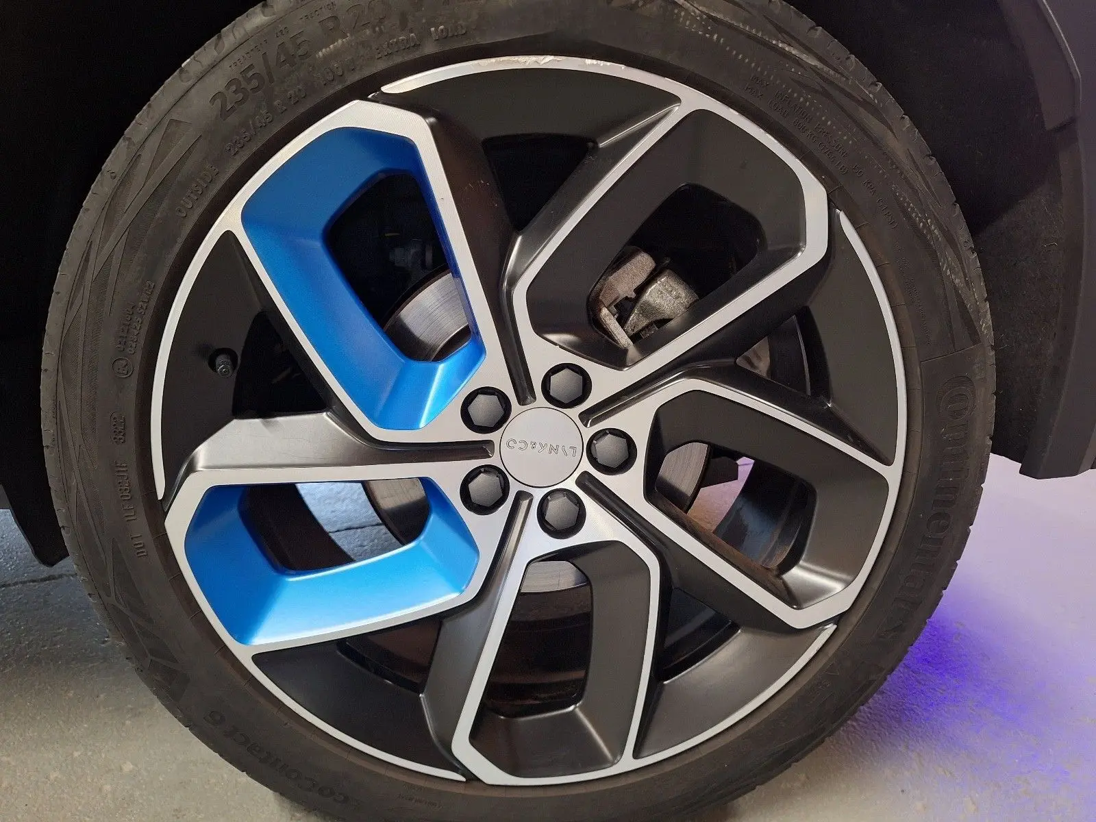 Gros plan sur la jante bi-ton noire et bleue du LYNK & CO 01 hybride rechargeable, soulignant son design moderne.