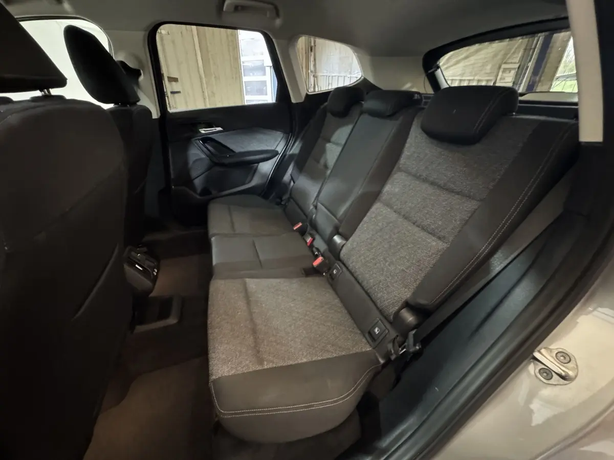 Vue intérieure côté droit des sièges arrière gris foncé du BMW X1 sDrive20i Business Design 2024.