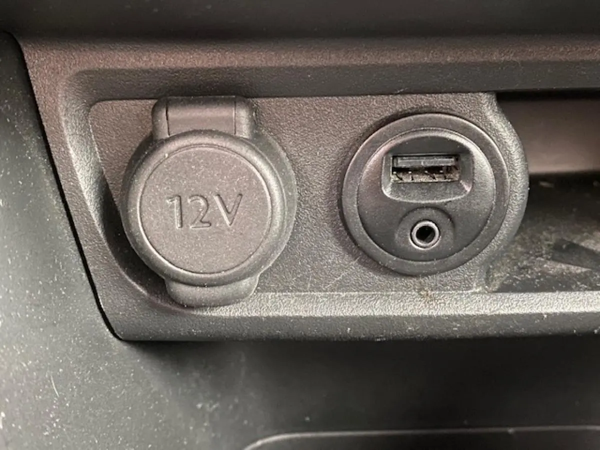 Prise 12V et port USB avec entrée audio en gros plan dans l’habitacle d’une Peugeot 2008 GT Line gris platinium.