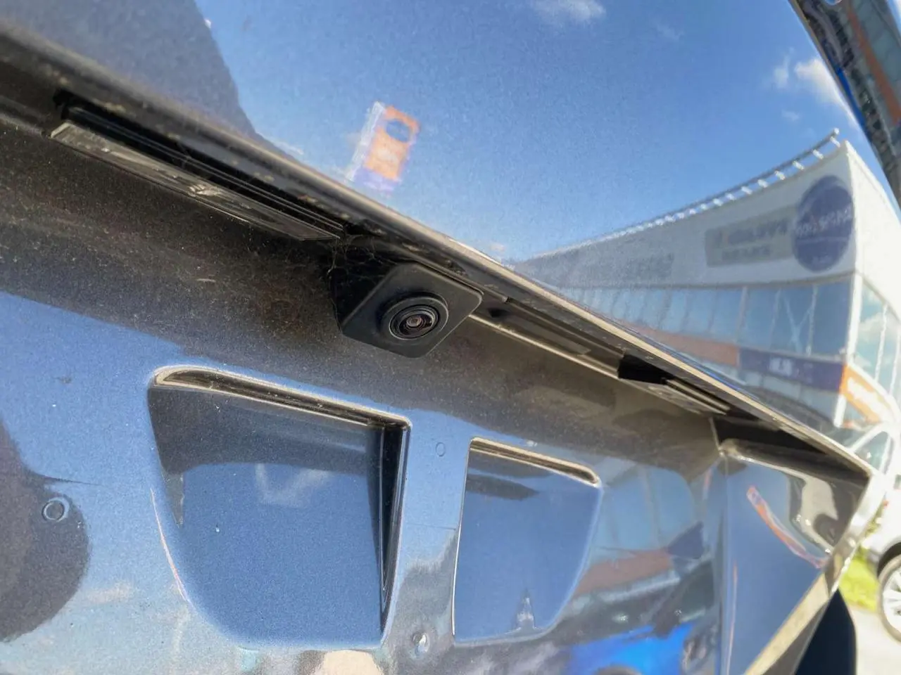 Gros plan sur la caméra de recul intégrée à la malle arrière du Peugeot 5008 gris platinium métallisé.