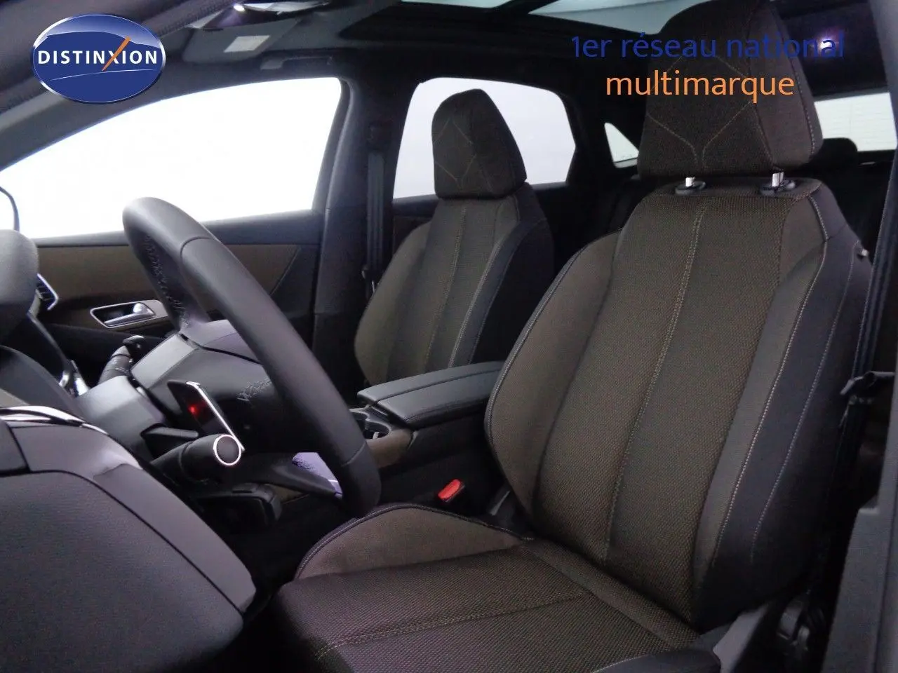 Vue intérieure côté conducteur du DS7 Crossback E-TENSE 2021 avec sièges tissu marron et volant multifonction.