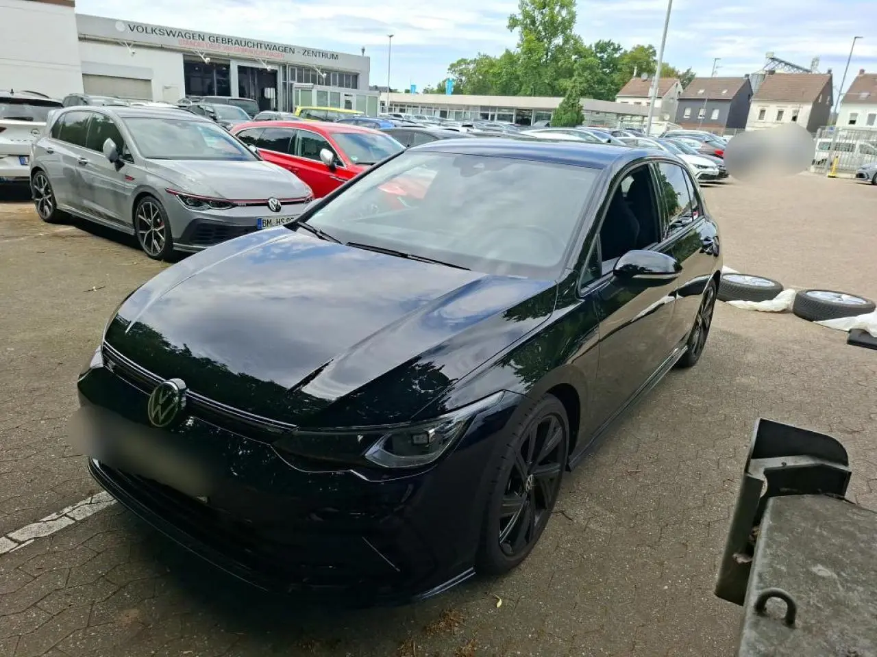 Volkswagen Golf 8 noire vue 3/4 avant droit avec jantes noires et calandre R-Line brillante