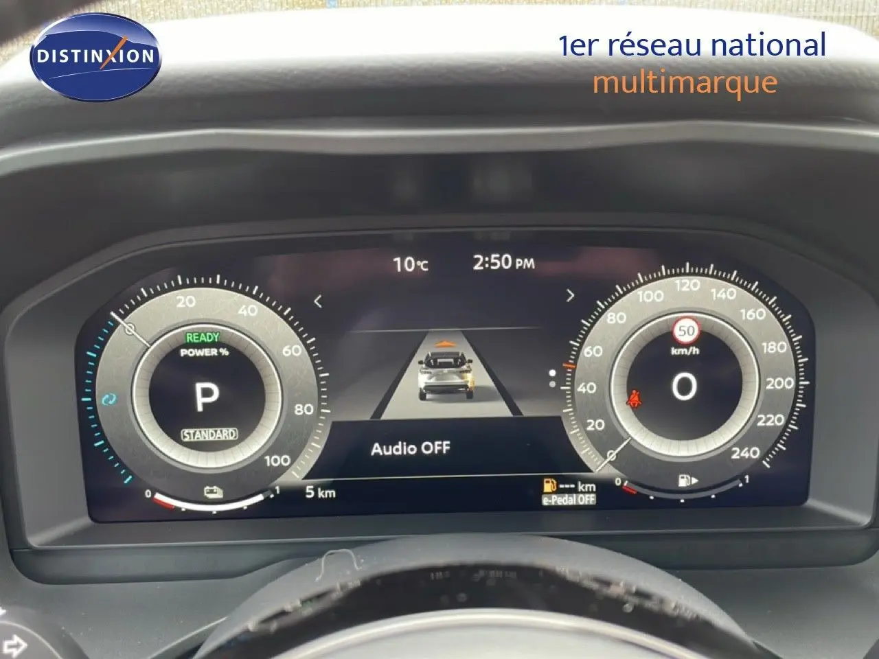 Vue rapprochée du tableau de bord numérique du Nissan Qashqai gris, affichant la vitesse et le mode de conduite.