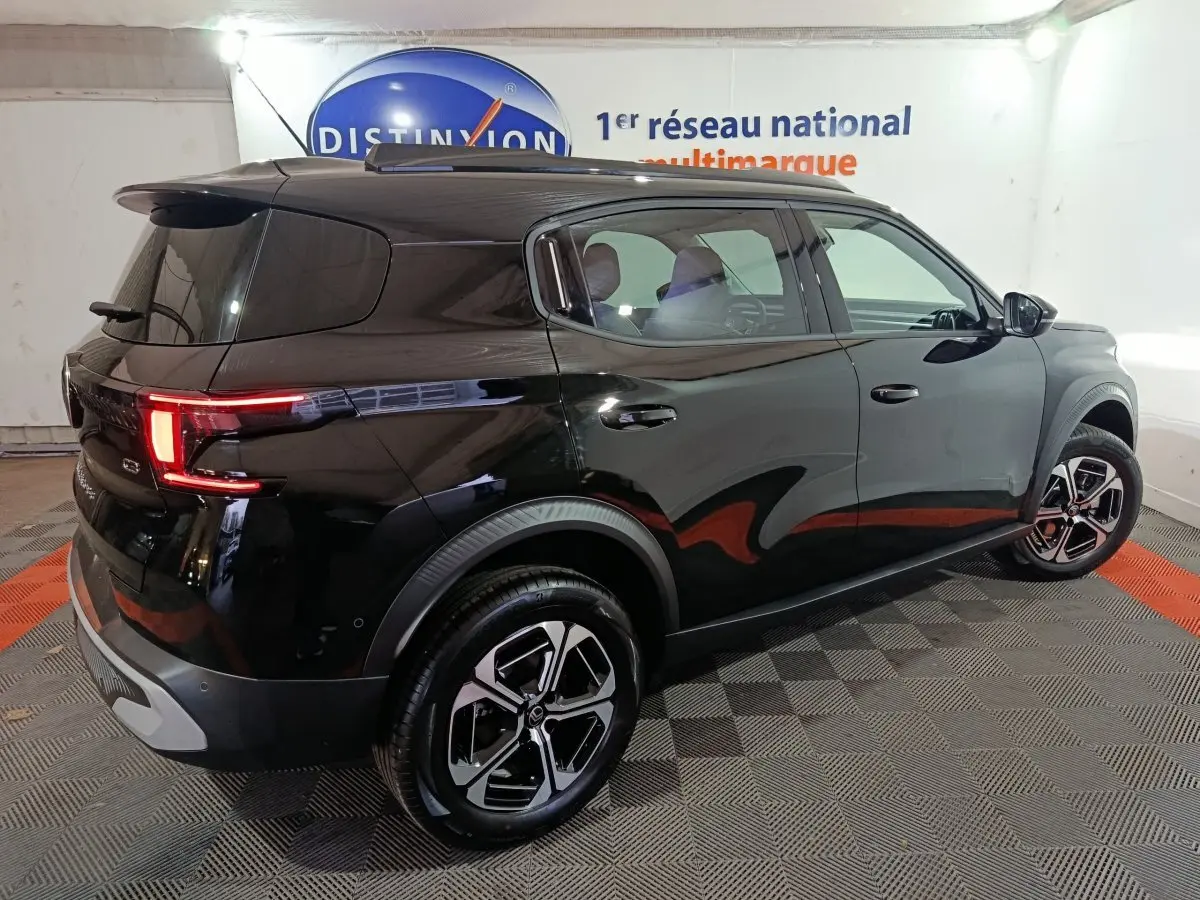 Vue 3/4 arrière droite d'une Citroën C3 Hybride noire 2025 avec feux LED et jantes alliage distinctives.