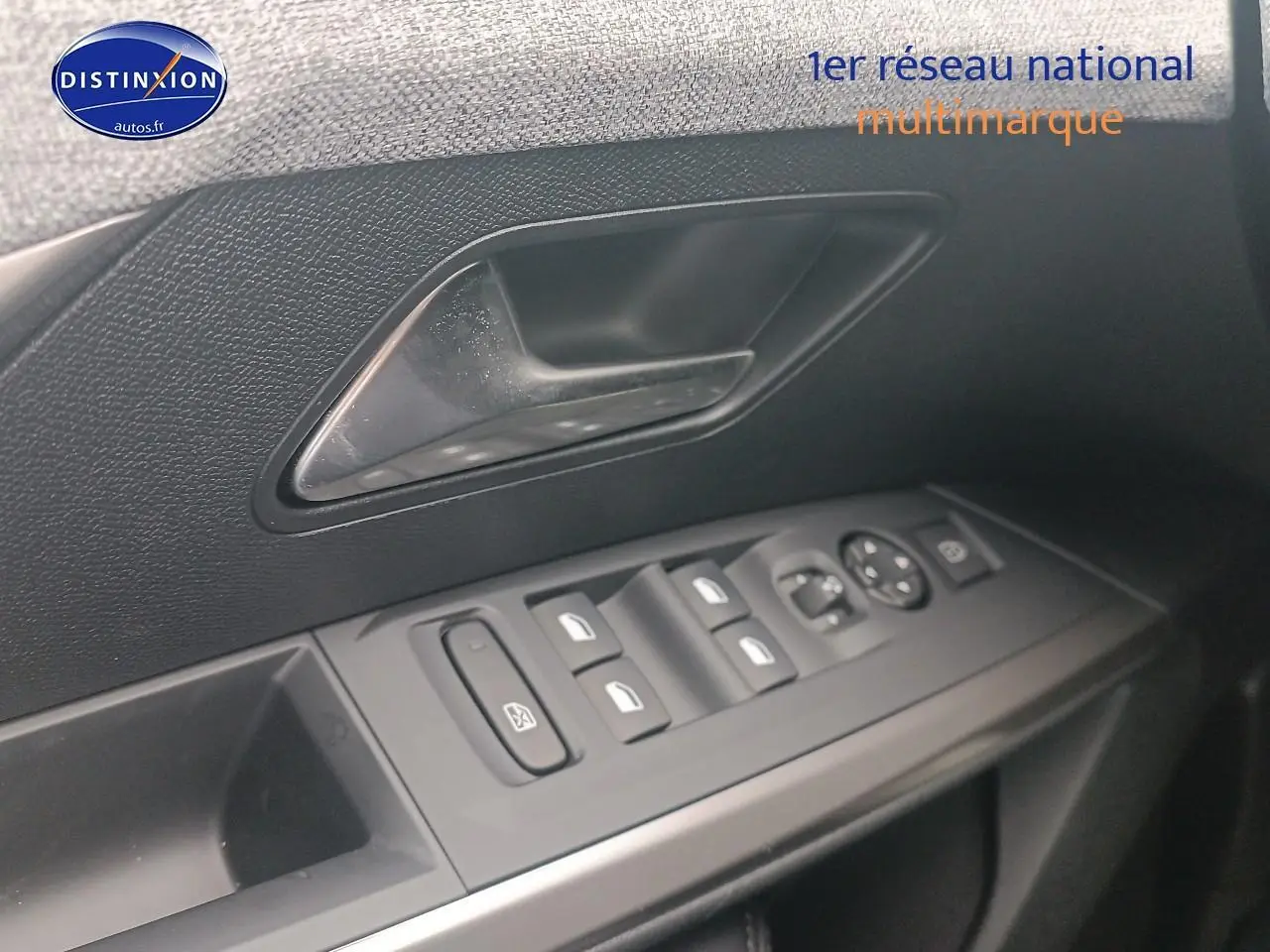 Gros plan sur la commande des vitres côté conducteur du Peugeot 5008 gris Artense, avec poignée de porte noire.