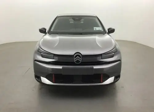 Vue frontale d'une Citroën C4 hybride 2025 gris Mercury avec calandre noire et détails rouges sur le pare-chocs.