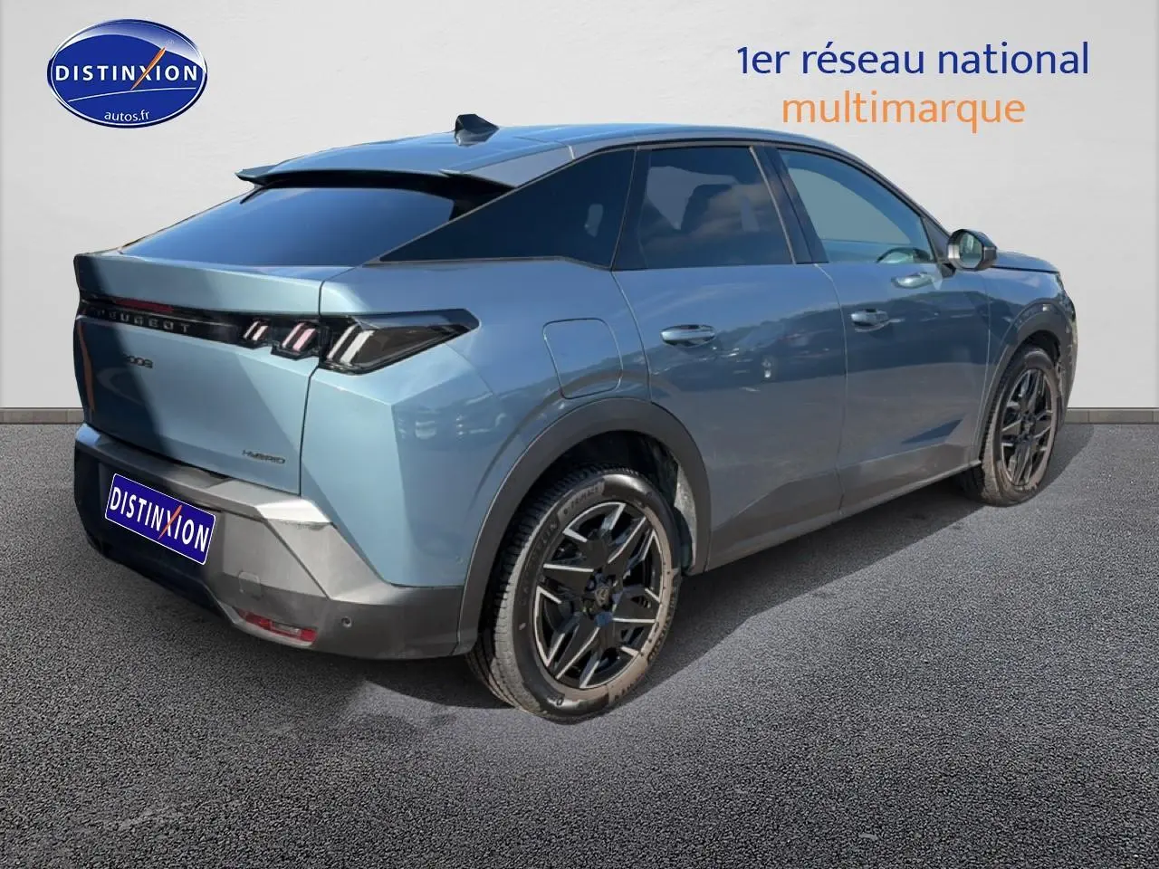 Vue 3/4 arrière droite d’un Peugeot 3008 hybride bleu 2025 avec jantes alu et becquet arrière noir.