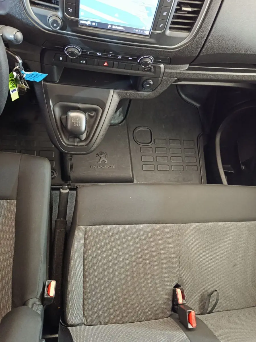 Vue intérieure centrée sur la console centrale et levier de vitesses manuelle du Peugeot Expert Fourgon, sièges gris.