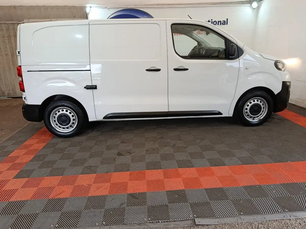 Profil droit du Peugeot Expert Fourgon blanc 2023, version Taille M, avec portes latérales coulissantes et jantes acier.