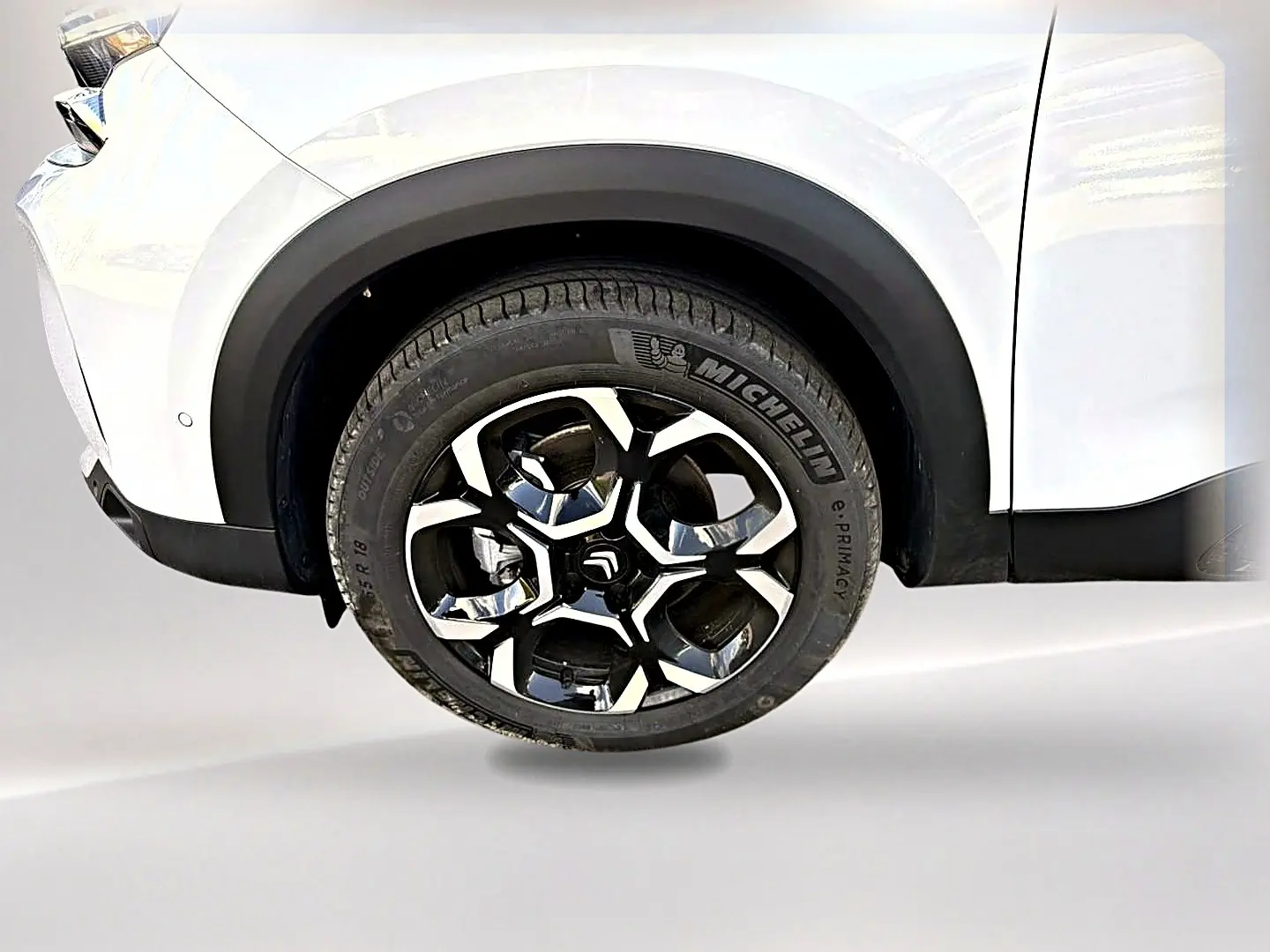 Gros plan sur la roue avant droite du Citroën C5 Aircross blanc, jante alliage noire et argentée, pneu Michelin.