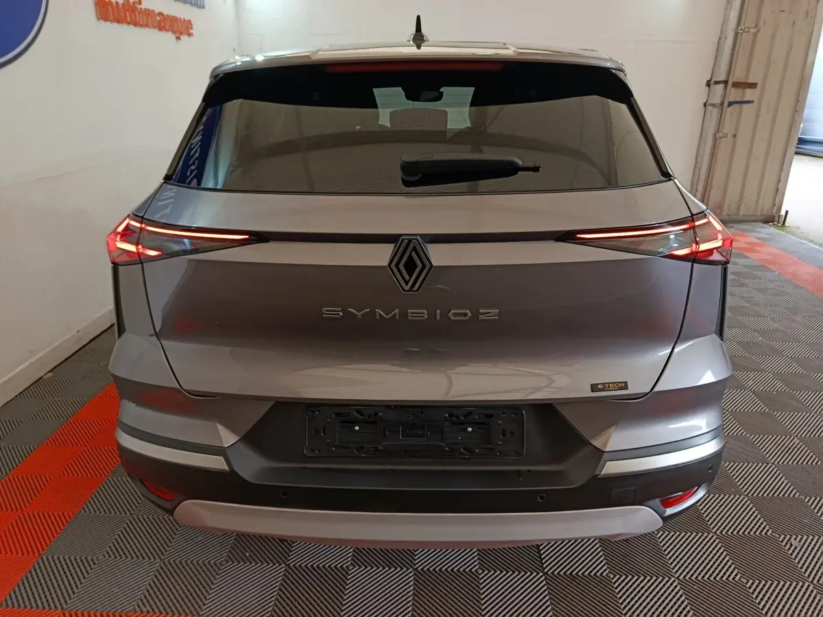 Vue arrière d'une Renault SYMBIOZ gris métallisé avec feux LED fins et logo central distinctif.