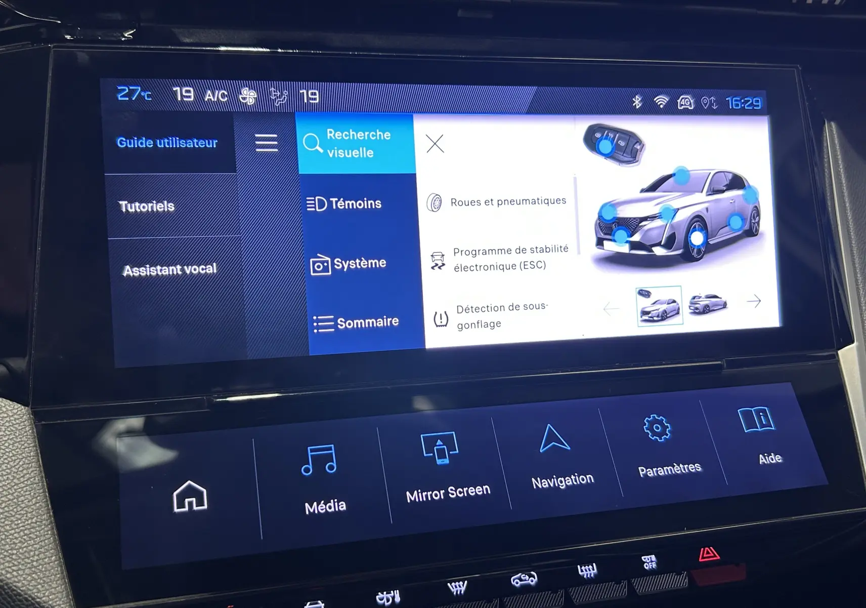 Écran tactile intérieur du Peugeot 308 gris 2022 montrant le menu d’aide avec options de navigation et système.