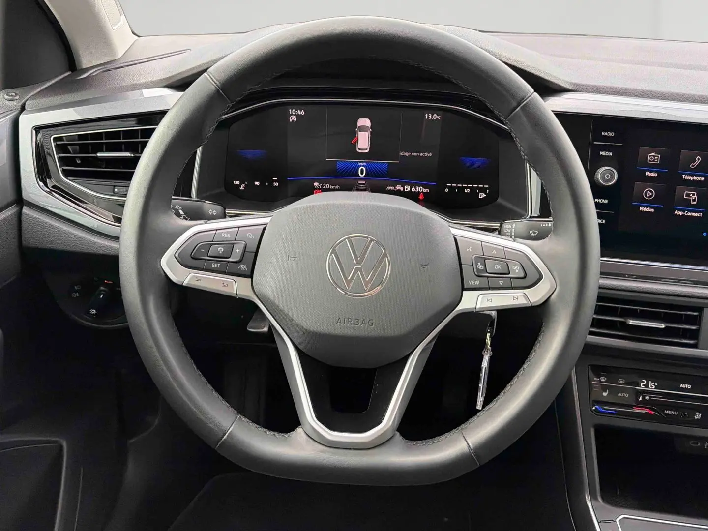Vue rapprochée du volant cuir noir et du tableau de bord digital de la Volkswagen Polo 2025 avec écran tactile central.
