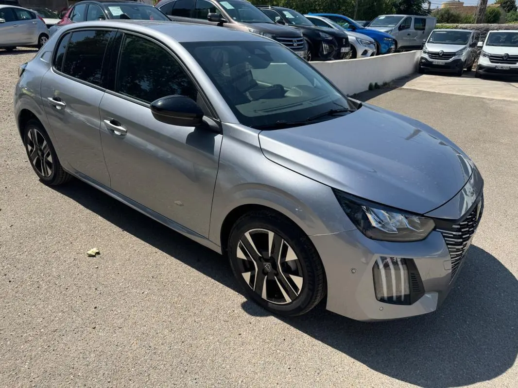 Peugeot 208 Hybrid gris vue 3/4 avant droit, avec jantes alliage 16 pouces et vitres teintées.