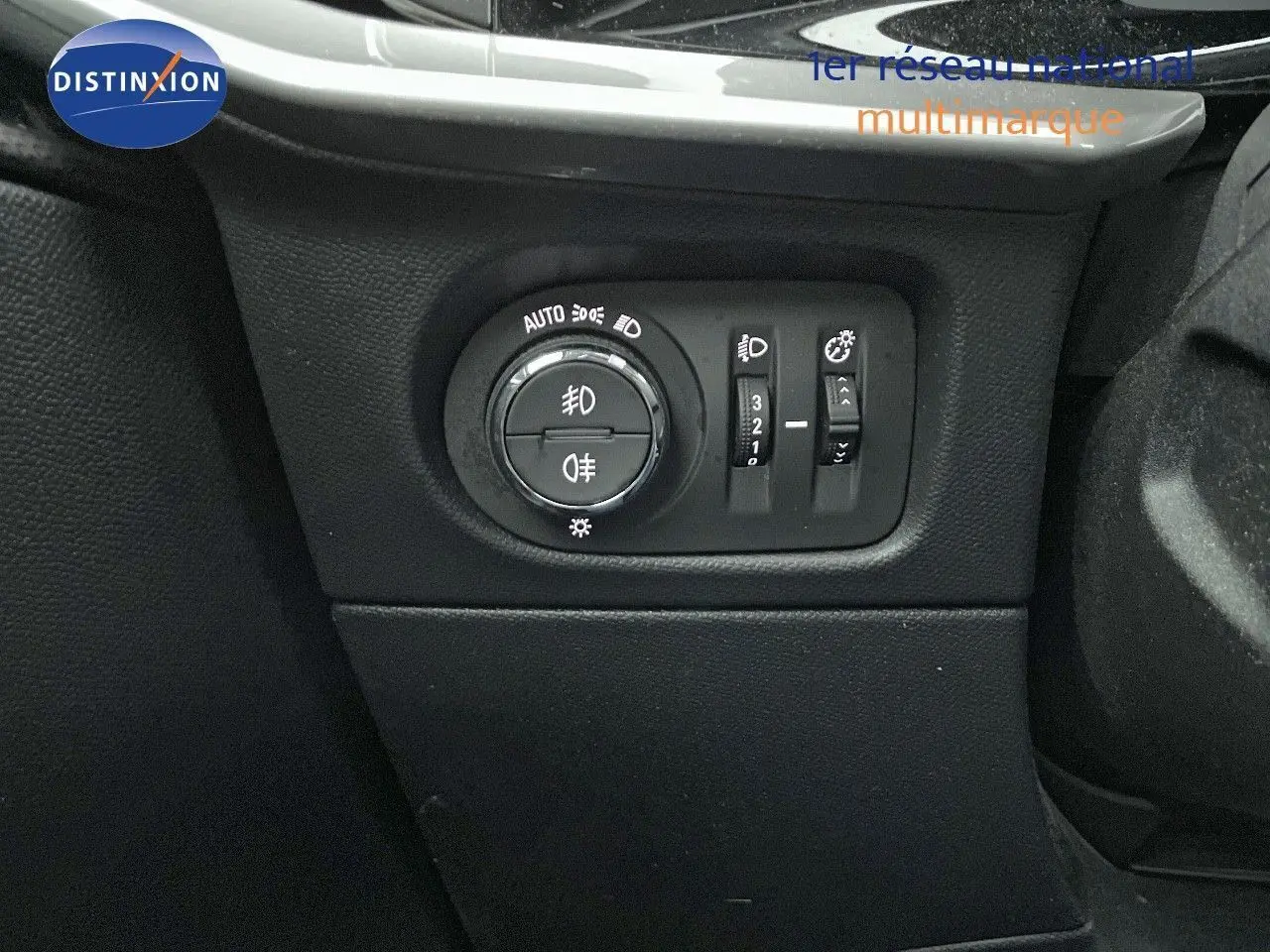 Gros plan sur le panneau de commande des phares dans l'habitacle de l'Opel Mokka gris Artens 2021.