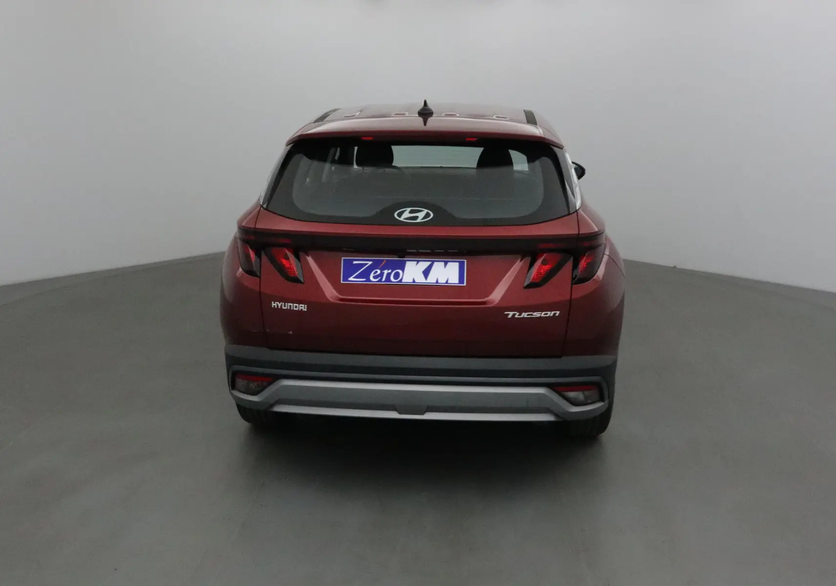 Vue arrière d'un Hyundai Tucson 2025 rouge Ultimate avec feux arrière modernes et logo Hyundai visible.