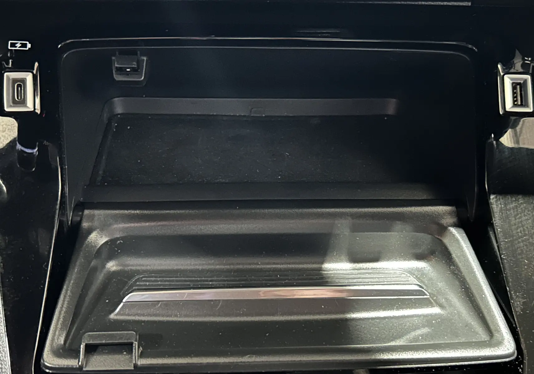 Gros plan sur la console centrale noire avec ports USB et prise allume-cigare du Peugeot 2008 Gris Artense.