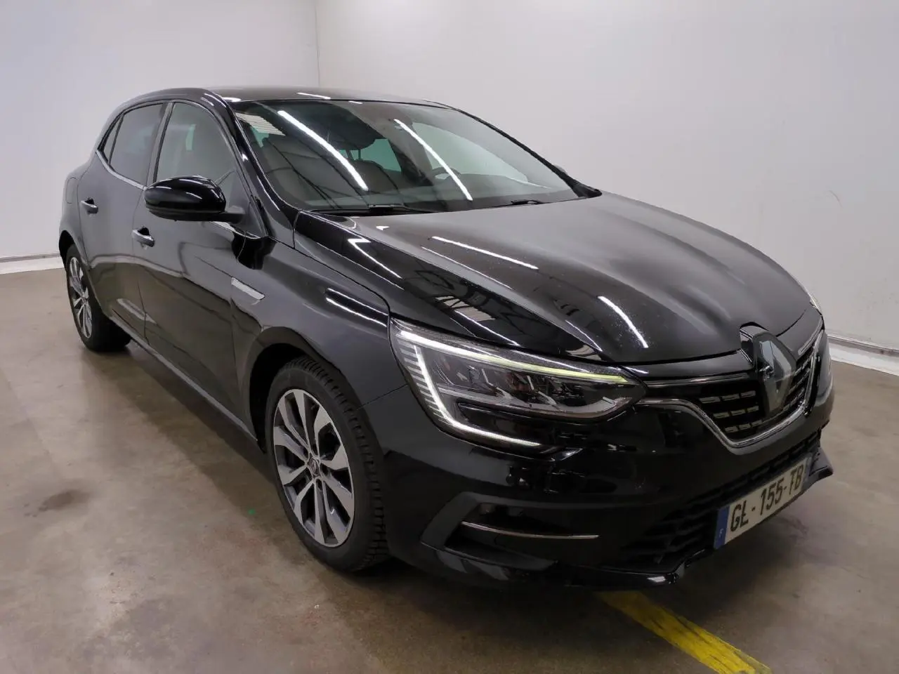 Renault Mégane noire métal vue 3/4 avant droit avec jantes alliage et feux LED signature en C.