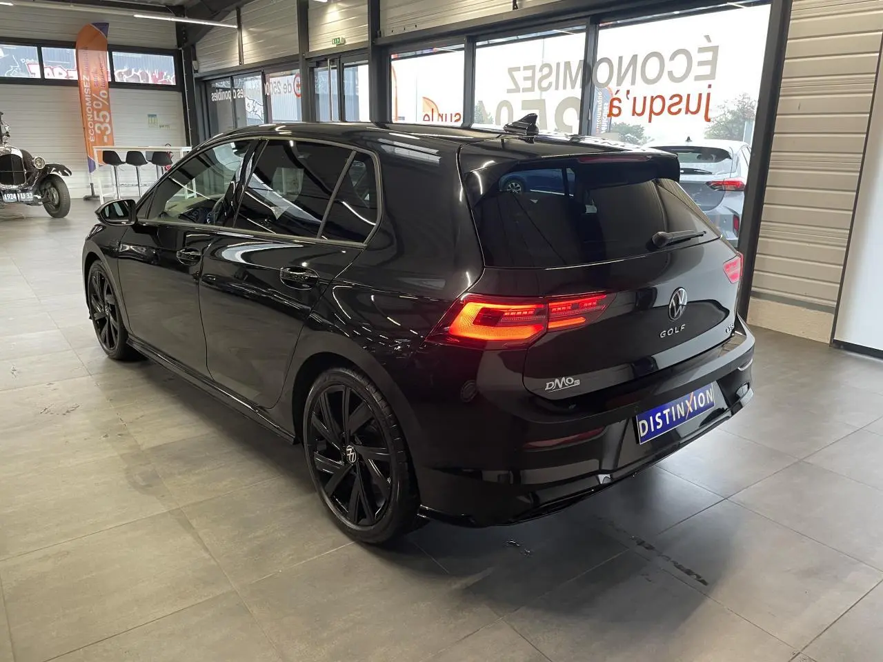 Volkswagen Golf VIII R-Line Black noir métal vue 3/4 arrière droit en intérieur avec jantes noires 18 pouces.