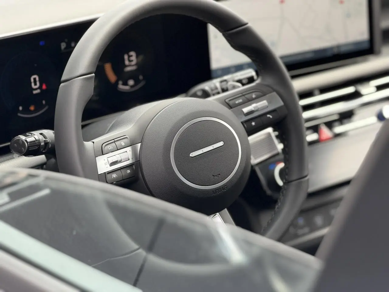 Gros plan sur le volant noir et le tableau de bord numérique du Hyundai Tucson 2026, intérieur moderne et épuré.