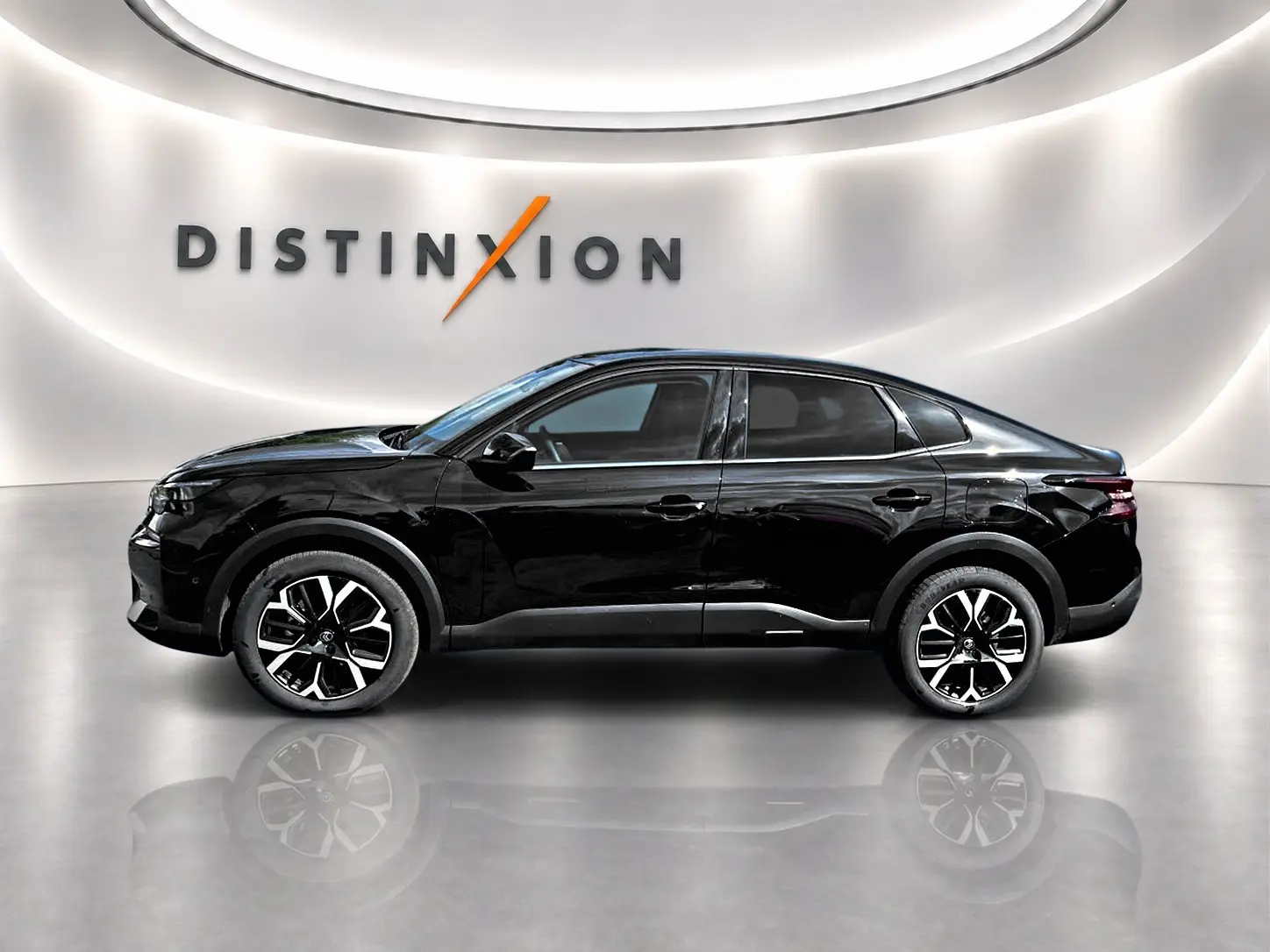 Profil côté gauche d'une Citroën C4 X noire 2025, avec jantes alu et vitres arrière surteintées en showroom lumineux.