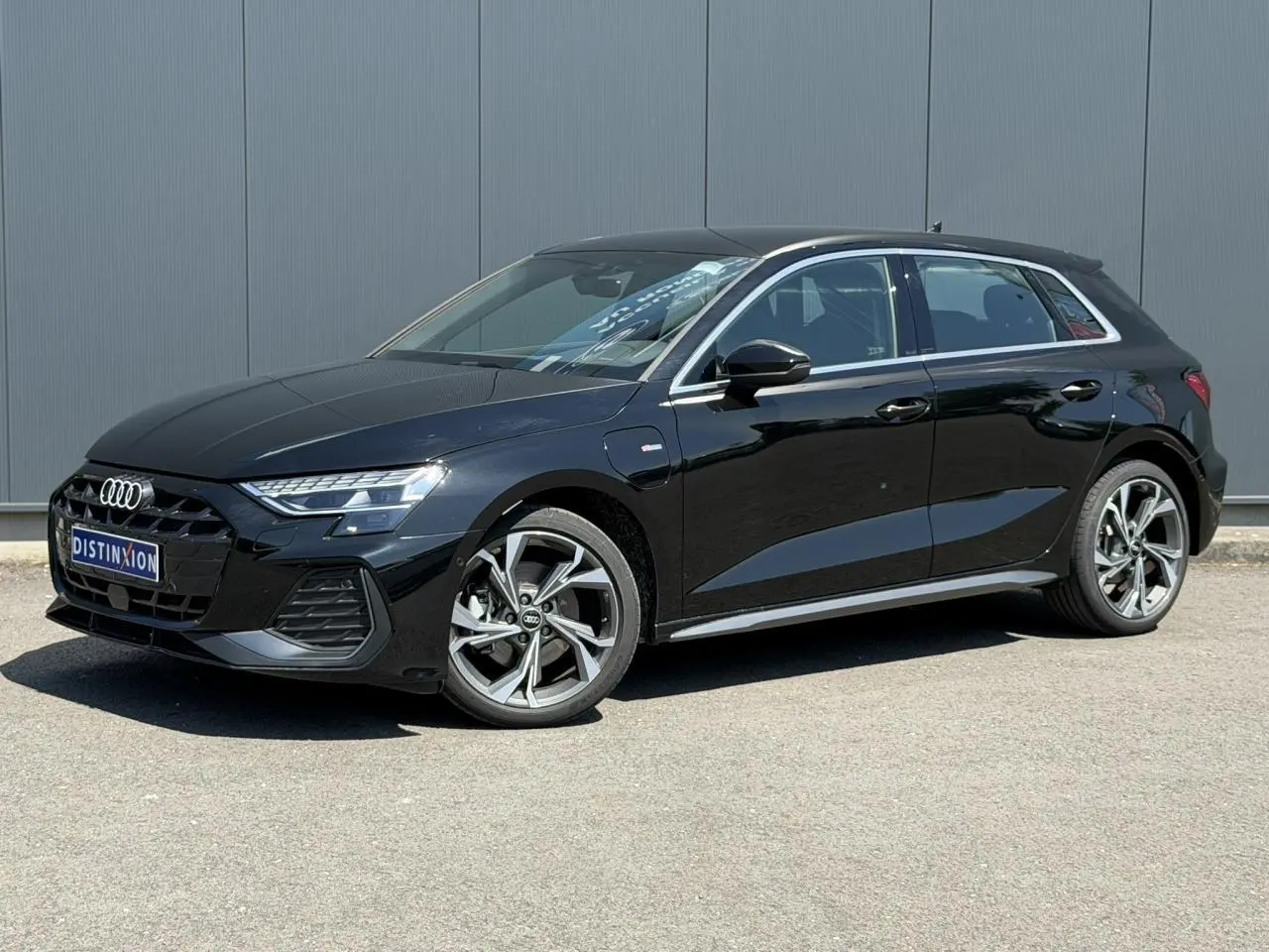 Audi A3 Sportback noir mythe vue 3/4 avant droit avec jantes alliage 5 branches en Y gris brillant.
