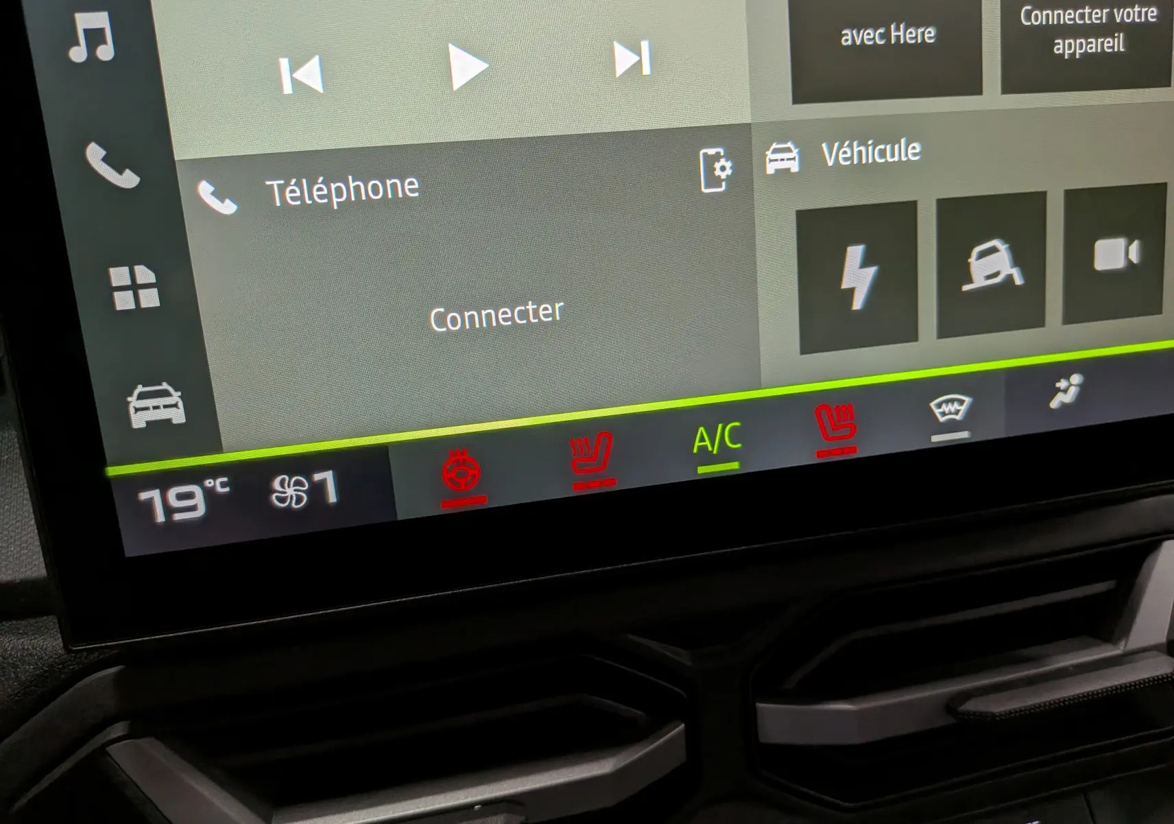 Écran tactile intérieur du Dacia Duster Hybrid-G 150 CH 4x4, affichant la climatisation à 19°C et les sièges chauffants activés.