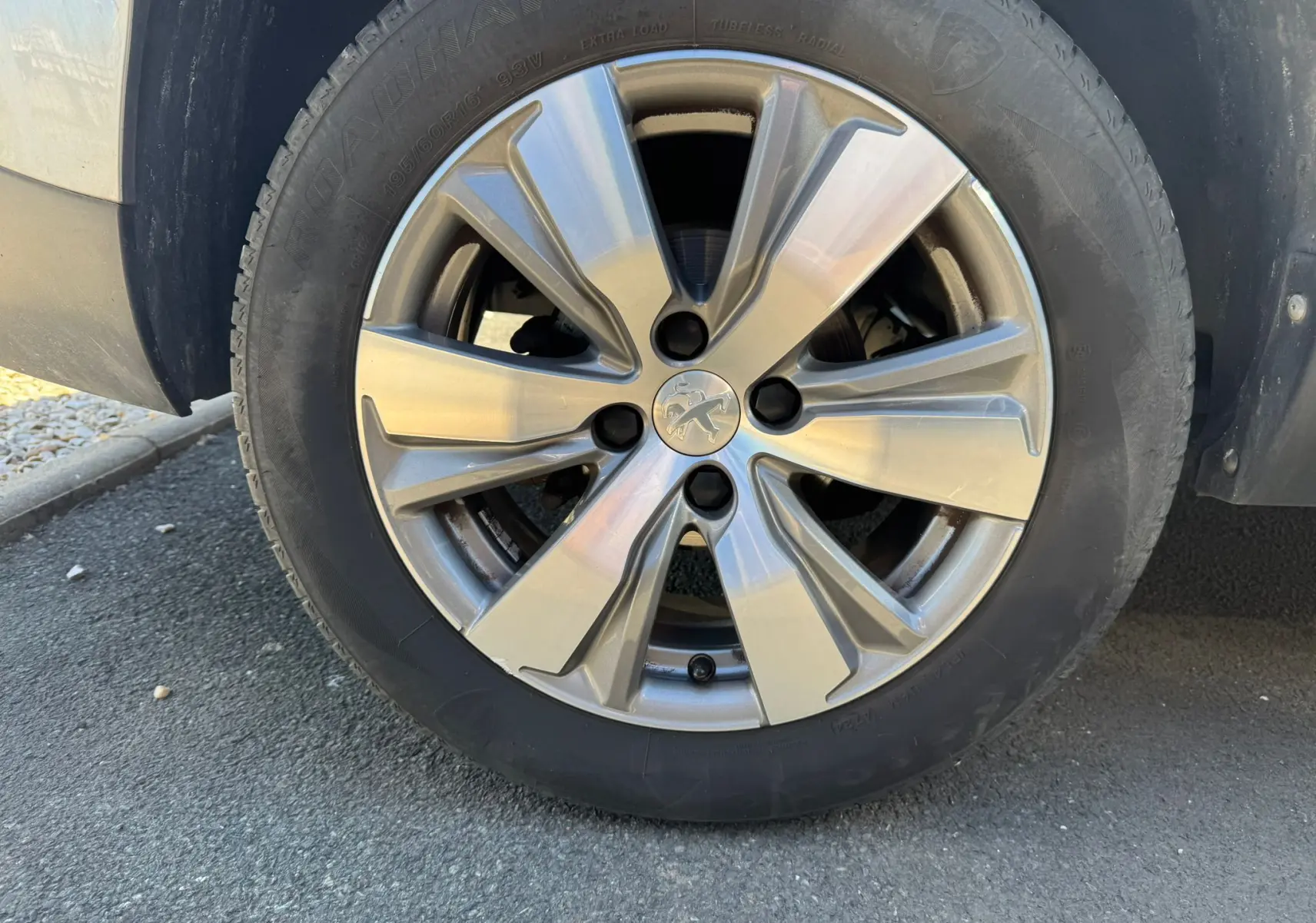 Gros plan sur la jante alliage argentée du côté gauche d’un Peugeot 2008 gris diesel de 2016.
