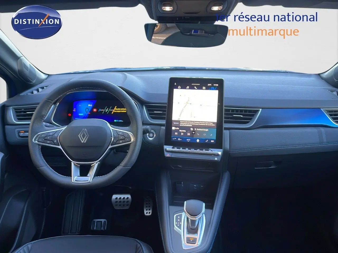 Intérieur avant du Renault Symbioz bleu Iron Metal, tableau de bord moderne avec écran tactile vertical et volant multifonction.