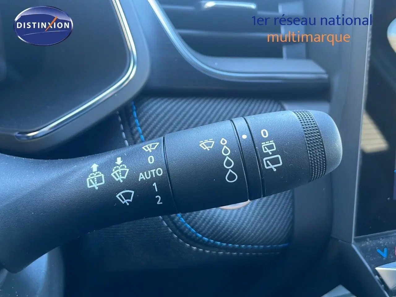 Gros plan sur la commande d'essuie-glace du Renault Symbioz E-Tech Full Hybrid 145 Esprit Alpine, intérieur noir avec surpiqûres bleues.