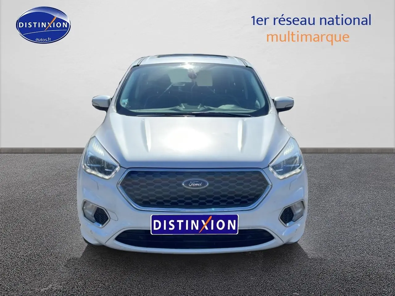 Vue frontale d'un Ford Kuga blanc 2017 avec calandre hexagonale et phares LED marqués.