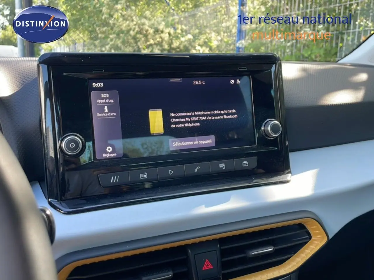 Vue rapprochée de l’écran tactile central du tableau de bord du SEAT Arona 2025 avec finition intérieure claire et détails jaunes.