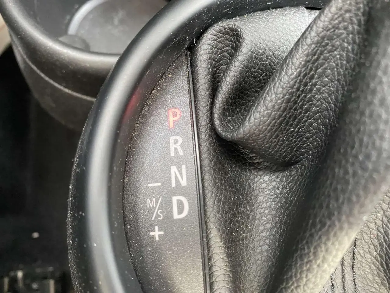 Gros plan sur le levier de vitesses automatique en cuir noir d’une MINI Countryman gris clair de 2015.